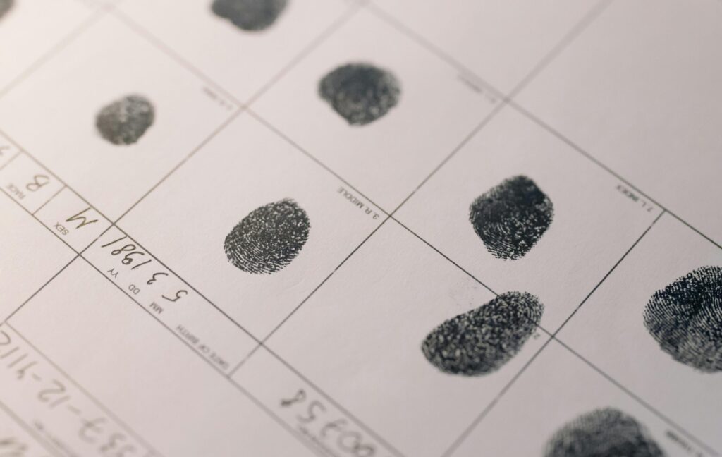 Detailed fingerprints on official document, highlighting identity verification process.